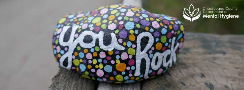 A Painted rock that says you rock on it with polka dots!