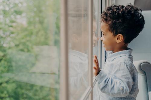 child looks out window