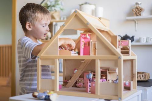 Child Playing with dollhouse