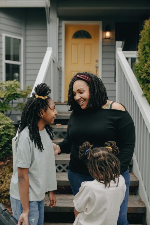 Mother and kids outside house